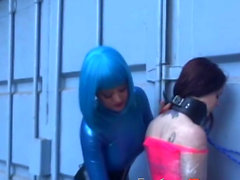 Latex Mistress Aradia restrains young dykes before toying